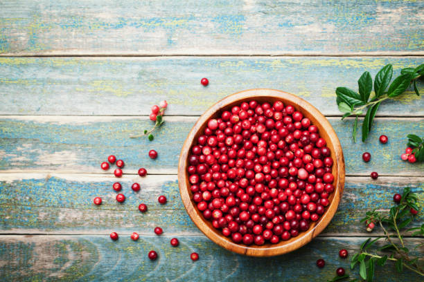 Organic fresh cranberries in a wooden bowl